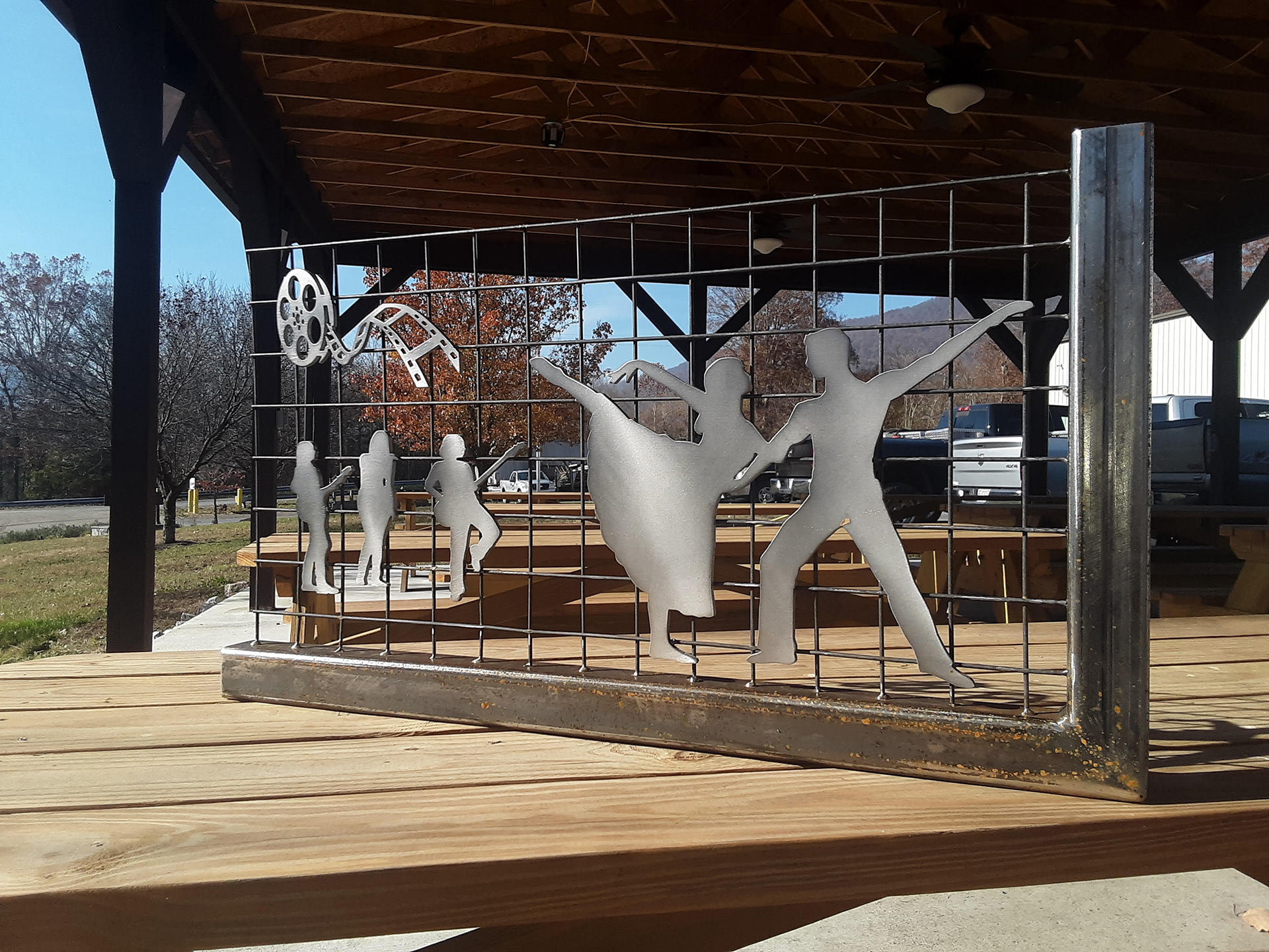 This photo is taken on the Amphitheatre grounds where the LOVE sculpture will sit. The sculpture will have the perfect backdrop of trees, foliage, Smith Creek.  It will be accessible by using the Amphitheatre Bridge or by parking on Church Street and walking to the sign.  Both are ADA compliant.